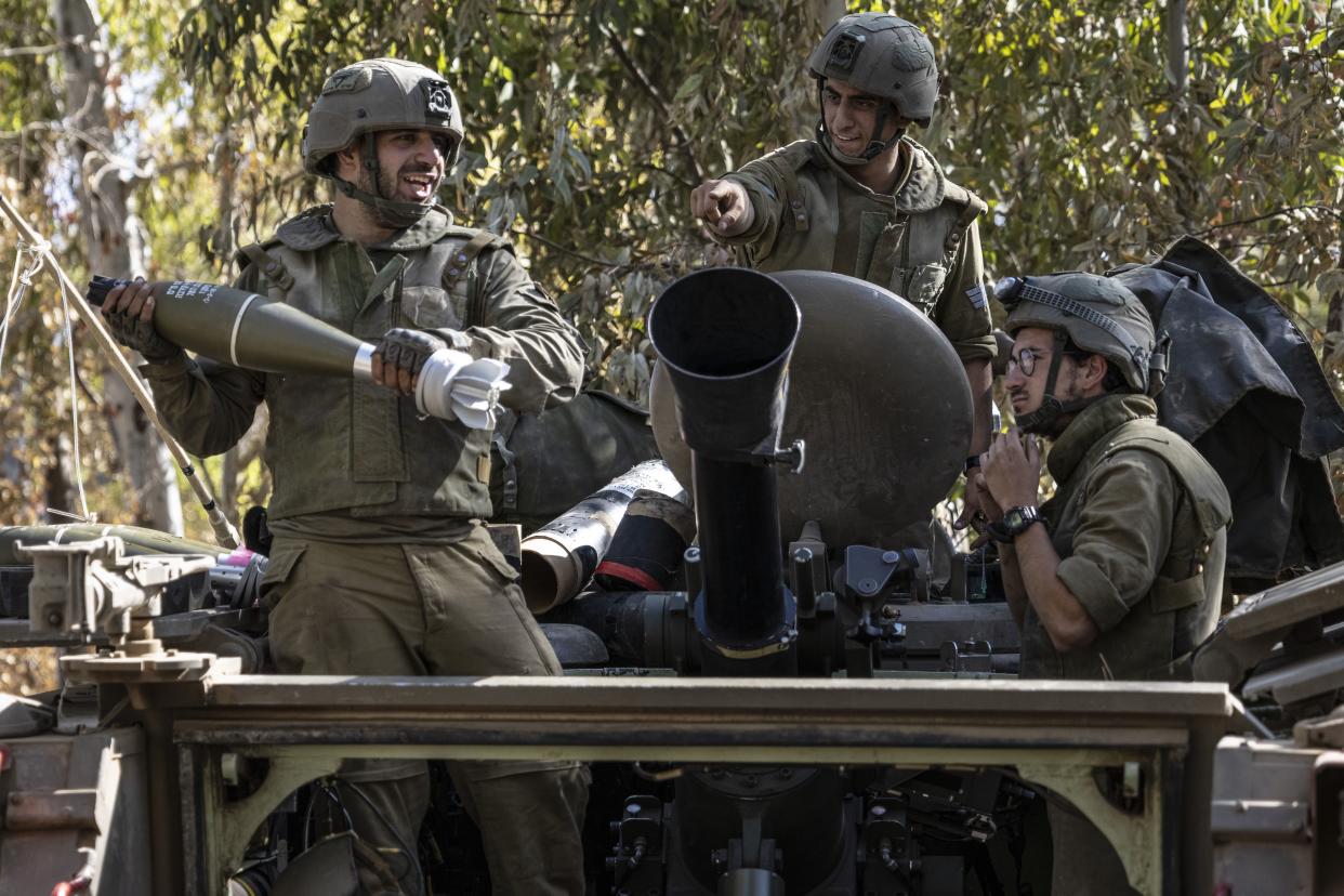 Israeli soldiers load ammunition onto an armored personal carrier at a staging ground near the Israeli Gaza border on Friday. 