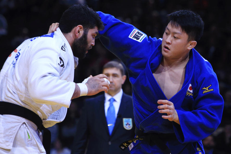 FILE - In this Sunday, Feb. 7, 2016, file photo, Or Sasson, of Israel, left, competes against Hisayoshi Harasawa, of Japan, during the men's +100 kg final at the Grand Slam Paris 2016 Judo tournament, in Paris. Judo is coming home at the Tokyo Olympics. Hisayoshi Harasawa, who lost to Teddy Riner in the Olympic final in Rio de Janeiro five years ago, was picked for another shot at the games. (AP Photo/Thibault Camus, File)