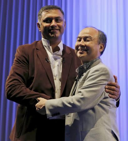 SoftBank Group Corp. Chairman and CEO Masayoshi Son (R) and President and COO Nikesh Arora shake hands during a special lecture of the SoftBank Academia in Tokyo, Japan October 22, 2015. REUTERS/Toru Hanai/File photo