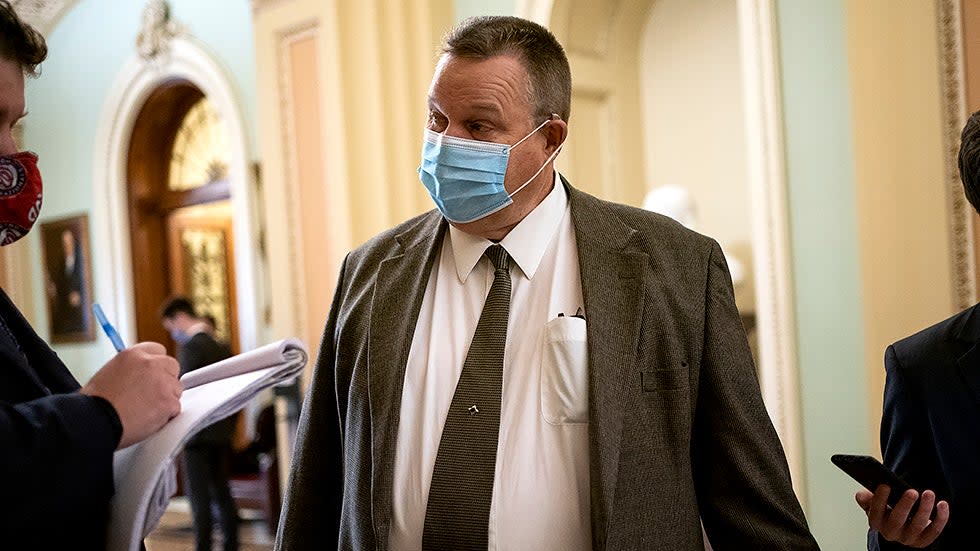 Sen. Jon Tester (D-Mont.) speaks to a reporter outside the Senate Chamber during a series of judicial nomination votes on Tuesday, October 26, 2021.