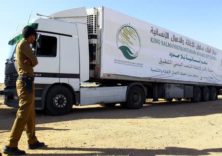 A Saudi security personnel stands next to a truck loaded with aid offered by King Salman Center for Relief and Humanitarian Aid to be sent to the Yemeni people, in Riyadh April 17, 2016. REUTERS/Faisal Al Nasser