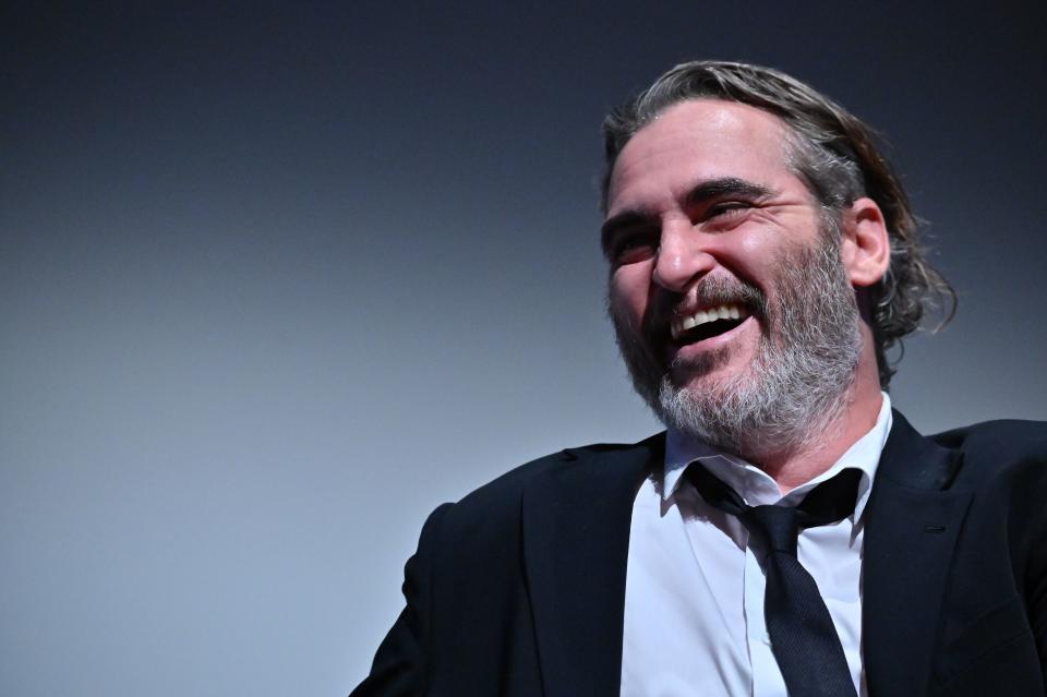 Joaquin Phoenix lets out a dashing smile for the camera in this photo and he looks amazing