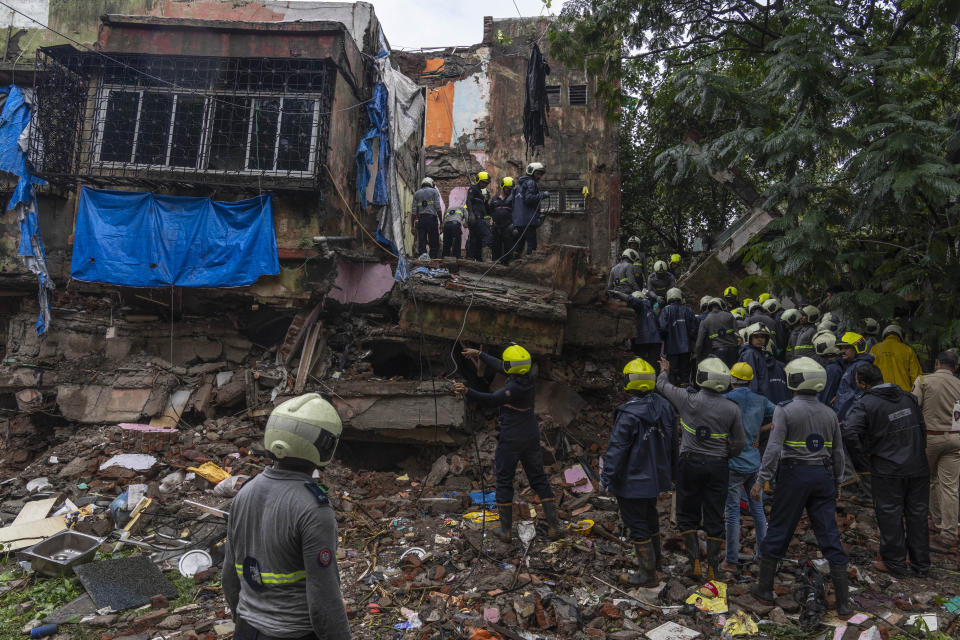 Rescuers look for survivors in the debris of a four-story residential building that collapsed in Mumbai, India, Tuesday, June 28, 2022. At least three people died and more were injured after the building collapsed late Monday night. (AP Photo/Rafiq Maqbool)