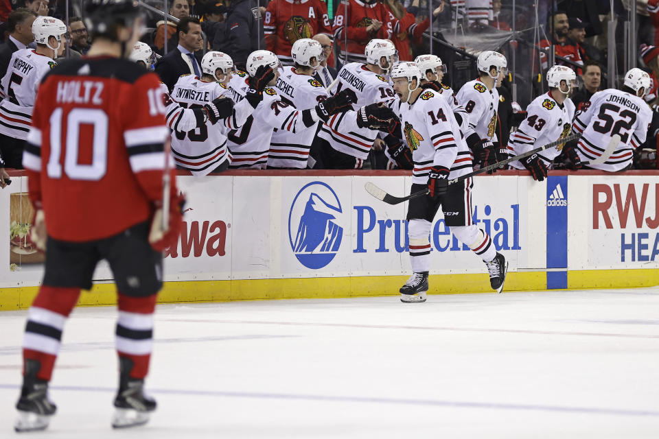 Chicago Blackhawks left wing Boris Katchouk (14) is congratulated for his goal against the New Jersey Devils during the second period of an NHL hockey game Friday, Jan. 5, 2024, in Newark, N.J. (AP Photo/Adam Hunger)