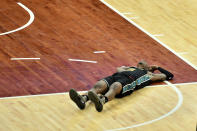 Memphis Grizzlies guard Ja Morant (12) lies on the court in the second half of an NBA basketball game against the Phoenix Suns, Monday, Jan. 18, 2021, in Memphis, Tenn. (AP Photo/Brandon Dill)