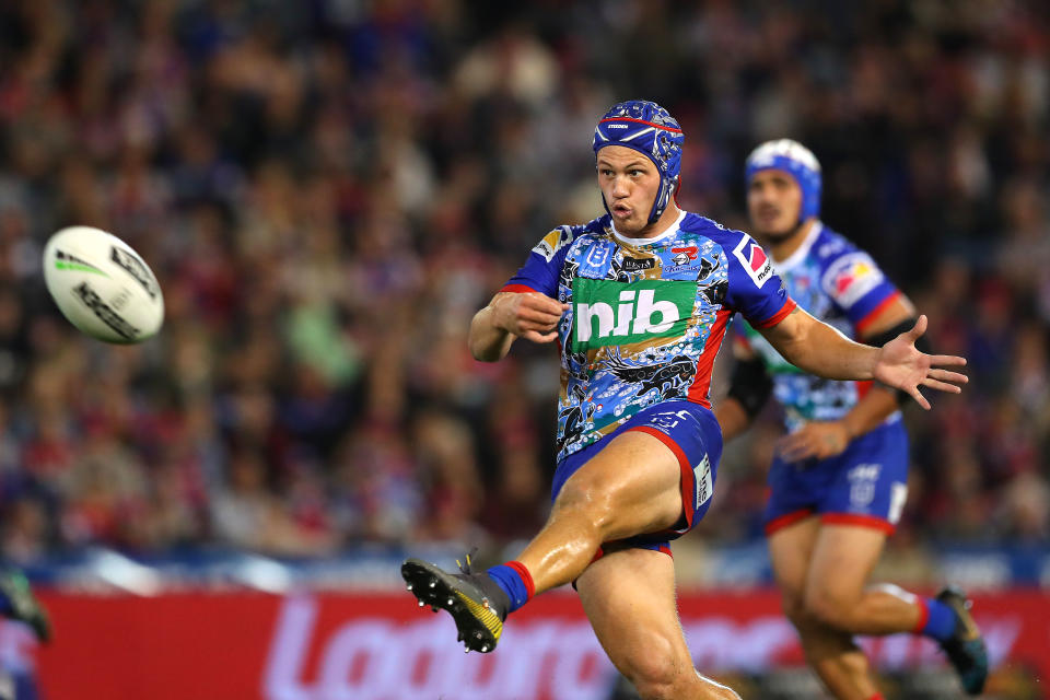 Kalyn Ponga for the Newcastle Knights kicks the ball.