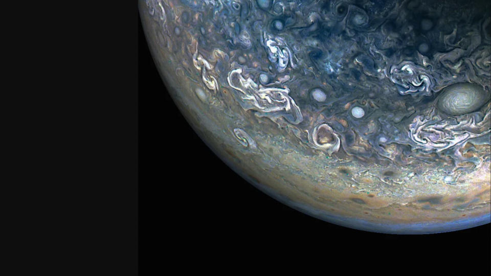  Closeup of jupiter and its swirling clouds against the blackness of space. 