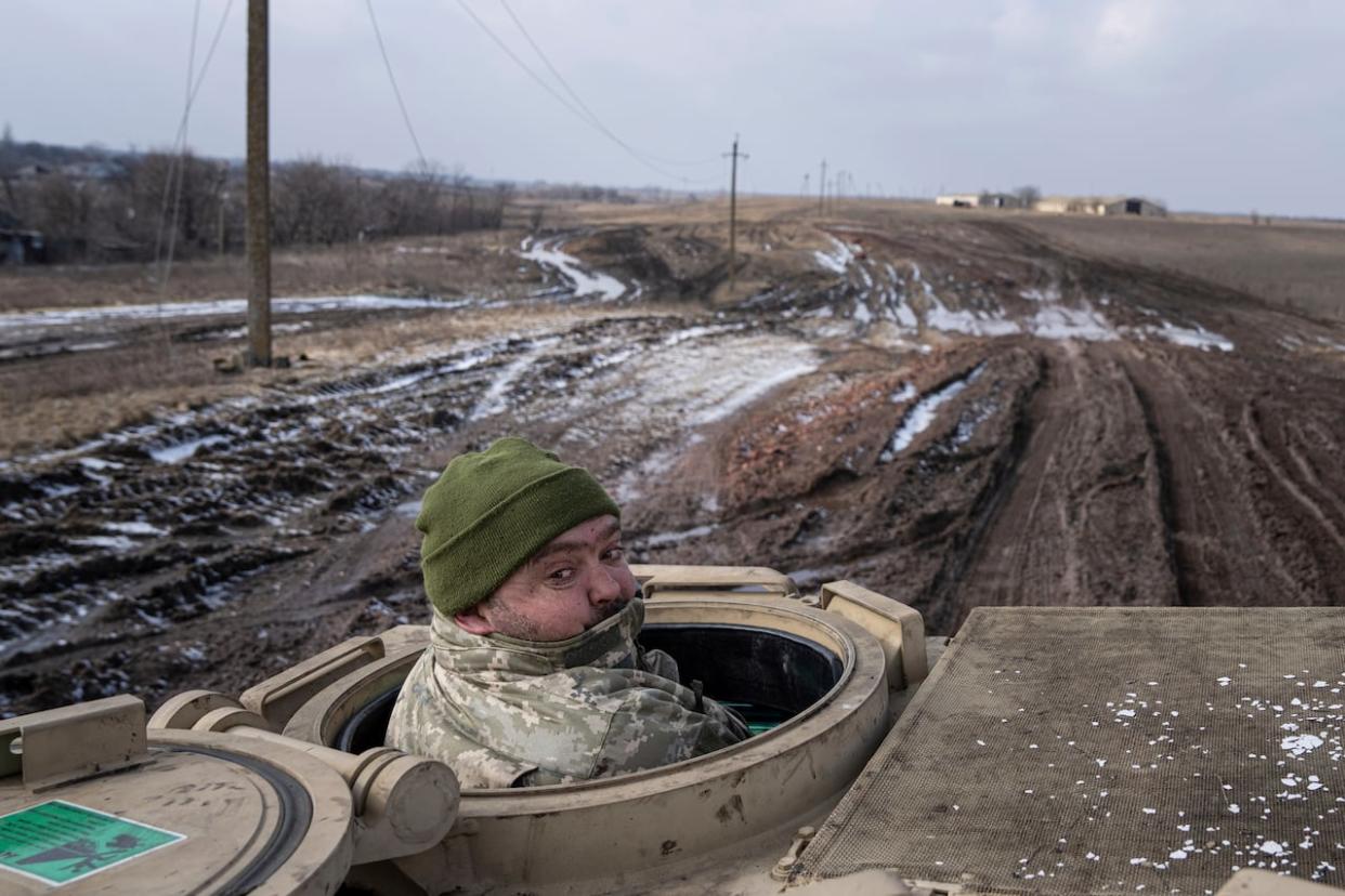 A Ukrainian serviceman of 68 Oleksa Dovbush brigade drives a M113 armoured personnel vehicle toward frontline positions near Vuhledar, Ukraine on Wednesday, Feb. 22, 2023. (Evgeniy Maloletka/AP - image credit)