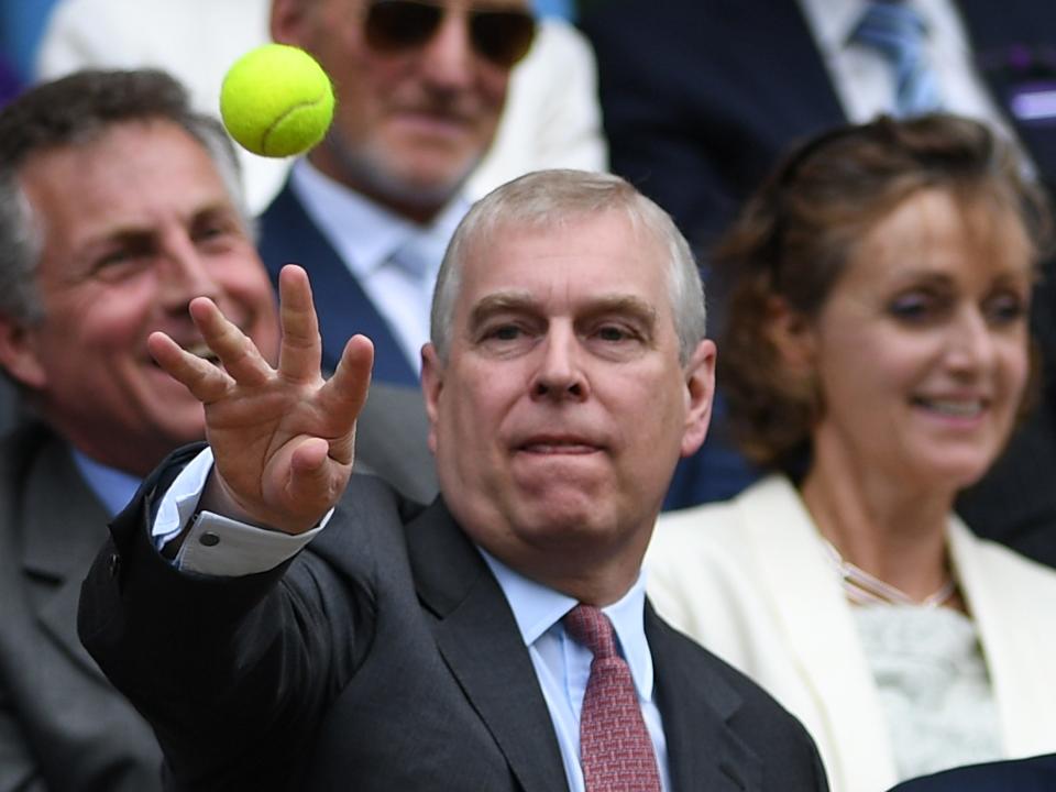 Prince Andrew throws a tennis ball during Wimbledon in 2016.