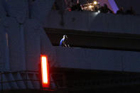 Sylvester Holt, bottom left, pleads with officers while standing on a ledge of the Crescent City Connection Friday, Jan. 20, 2017, in New Orleans. Holt was wanted in the connection with the shooting of his wife and a Westwego police officer. (AP Photo/Jonathan Bachman)