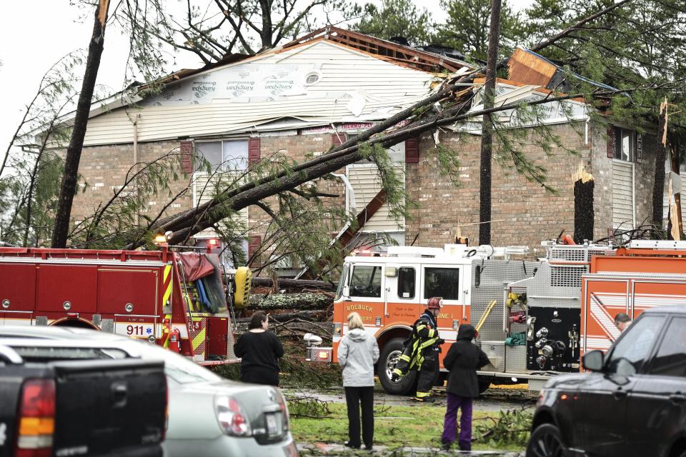 CORRECTS YEAR TO 2020 NOT 2019 - Emergency workers from the fire department respond to the scene of a damaged apartment complex Thursday, Feb. 6, 2020, in Spartanburg, S.C. A powerful winter storm brought severe weather across the Deep South early Thursday, with high winds causing damage that killed one person, injured several others and littered at least four states. (AP Photo/Sean Rayford)