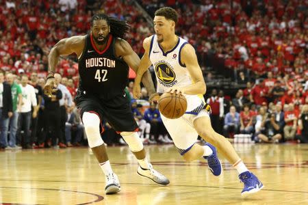 May 14, 2018; Houston, TX, USA; Golden State Warriors guard Klay Thompson (11) dribbles against Houston Rockets center Nene Hilario (42) during the fourth quarter in game one of the Western conference finals of the 2018 NBA Playoffs at Toyota Center. Mandatory Credit: Troy Taormina-USA TODAY Sports