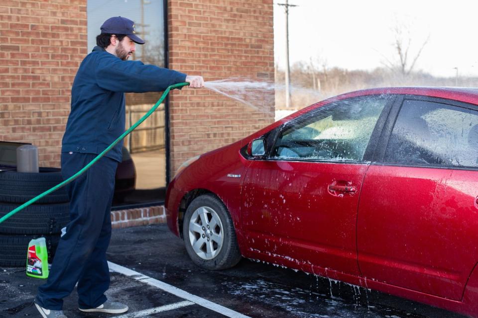 a person cleaning a car