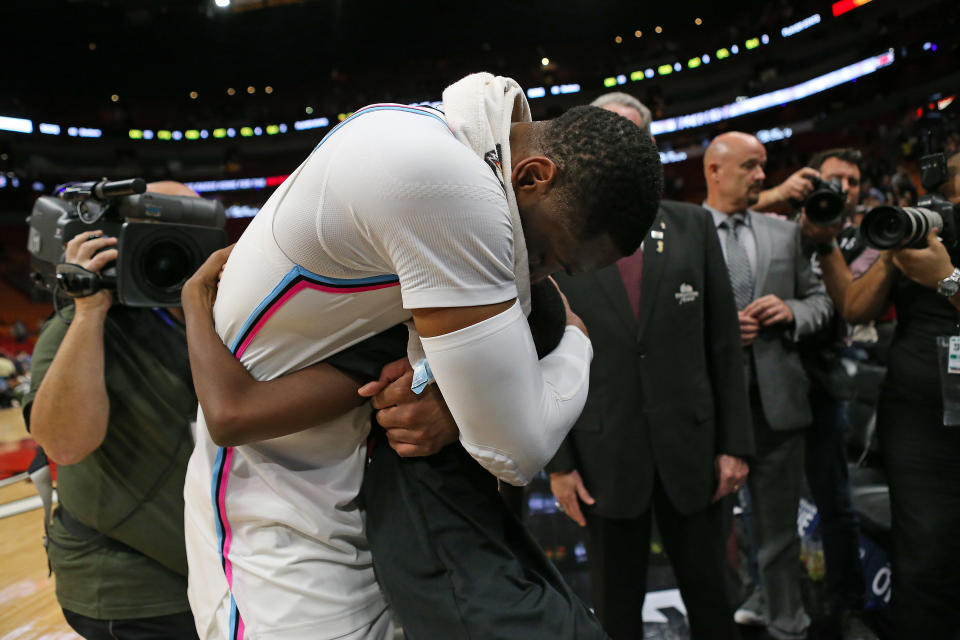 Miami Heat guard Dwyane Wade hugs his son, Zion, after a 91-85 win against the Milwaukee Bucks at the AmericanAirlines Arena in Miami on Friday, Feb. 9, 2018. (David Santiago/El Nuevo Herald/Tribune News Service via Getty Images)