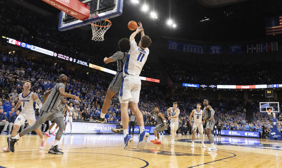 Butler's Landon Moore, center left, tips the ball away from Creighton's Ryan Kalkbrenner, center right, in the final 0.5 second during the second half of an NCAA college basketball game Friday, Feb. 2, 2024, in Omaha, Neb. (AP Photo/Rebecca S. Gratz)