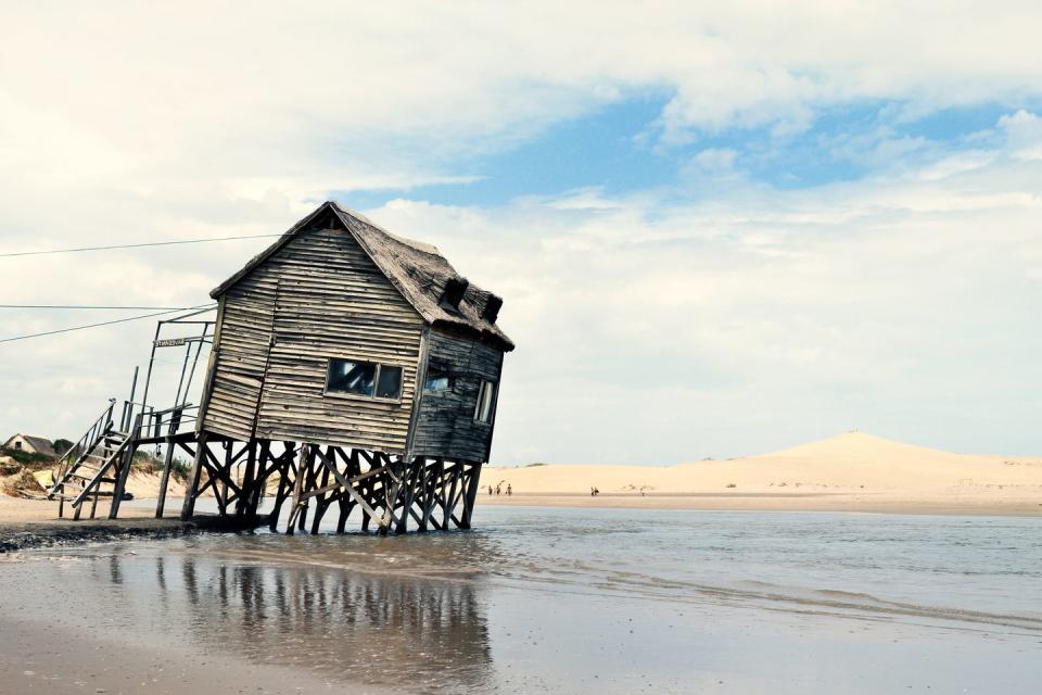 <p>Old wooden posts barely keep this former seaside getaway above water.</p>