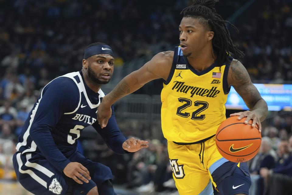 Marquette's Sean Jones gets past Butler's Posh Alexander during the first half of an NCAA college basketball game Wednesday, Jan. 10, 2024, in Milwaukee. (AP Photo/Morry Gash)