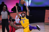Los Angeles Lakers' Anthony Davis (3) reaches for the ball as Houston Rockets' James Harden defends during the second half of an NBA conference semifinal playoff basketball game Thursday, Sept. 10, 2020, in Lake Buena Vista, Fla. (AP Photo/Mark J. Terrill)