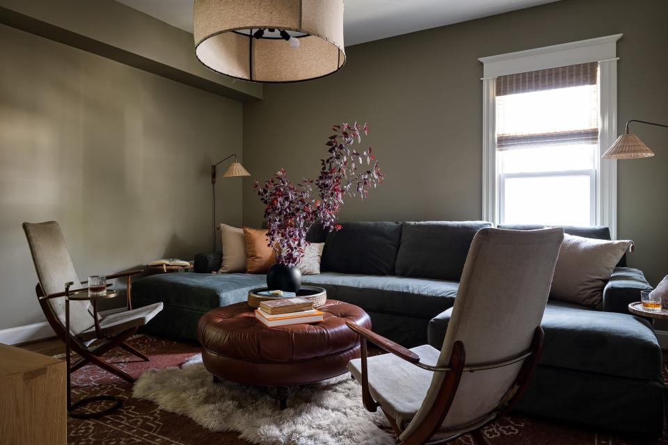 The family room features a slipcovered sofa for easy cleaning at this renovated American Foursquare Craftsman home in Old Louisville.