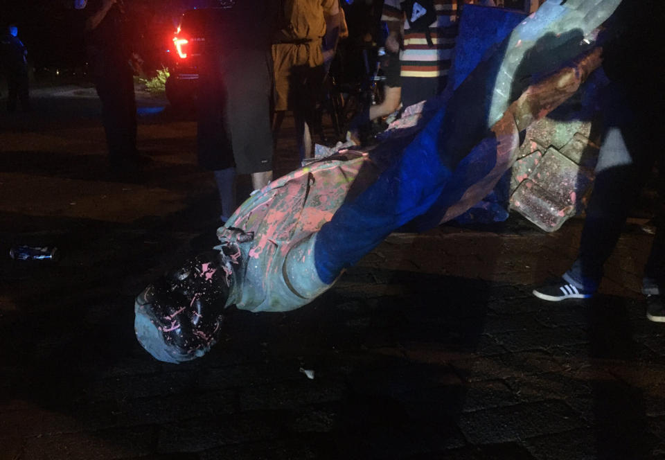 The statue of Confederate President Jefferson Davis is splattered with paint after it was toppled Wednesday night, June 10, 2020, along Monument Drive in Richmond, Va. (Dylan Garner/Richmond Times-Dispatch via AP)