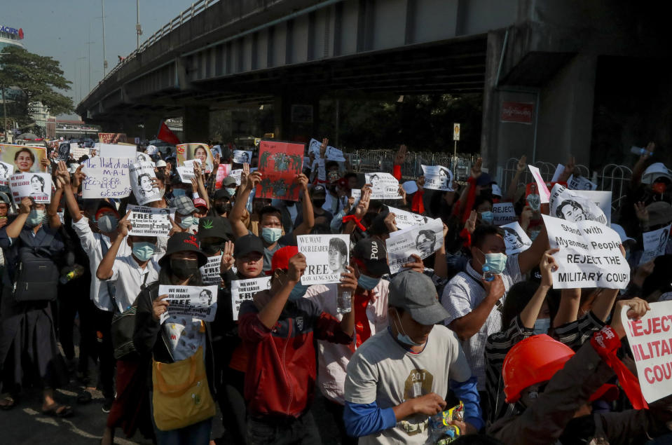 Demonstrators display placards calling for the release of detained Myanmar State Counselor Aung San Suu Kyi in Yangon, Myanmar Tuesday, Feb. 9, 2021. Demonstrators against Myanmar's military takeover took to the streets again Tuesday in defiance of new rules that make their protests illegal. (AP Photo)