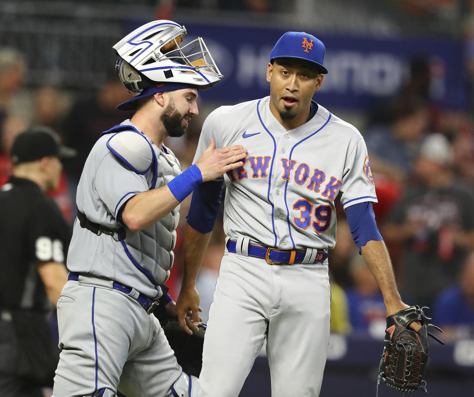 New York Mets pitcher Edwin Diaz, right, and catcher omas Nido celebrate after closing out the Atlanta Braves for a victor in a baseball game Monday, July 11, 2022, in Atlanta. (Curtis Compton/Atlanta Journal-Constitution via AP)