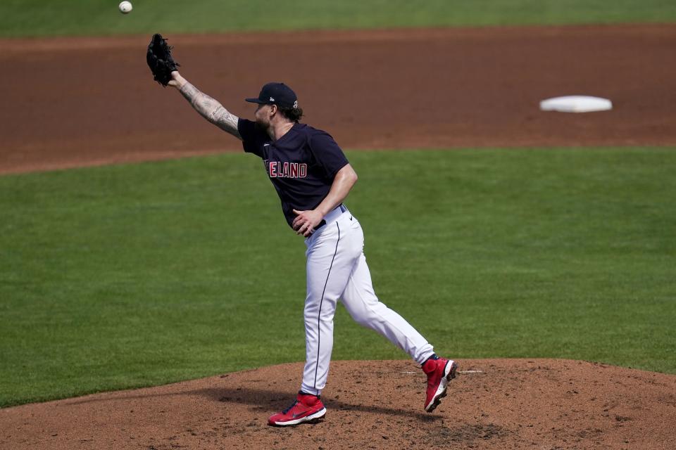 Cleveland Indians starting pitcher Logan Allen is unable to get a glove on a sharp single hit by Oakland Athletics' Frank Schwindel during the second inning of a spring training baseball game Monday, March 15, 2021, in Goodyear, Ariz. (AP Photo/Ross D. Franklin)