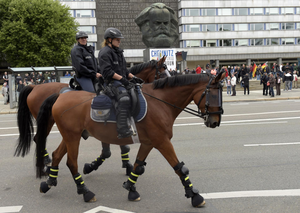 <p>Mounted police pass by the the Karl Marx statue as they are on patrol in Chemnitz, eastern Germany, Saturday, Sept. 1, 2018, after several nationalist groups called for marches protesting the killing of a German man last week, allegedly by migrants from Syria and Iraq. (Photo: Jens Meyer/AP) </p>