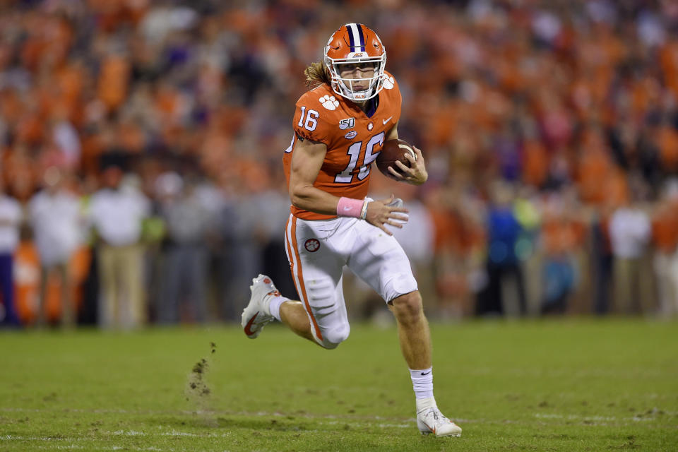 Trevor Lawrence runs with the ball in his hands.