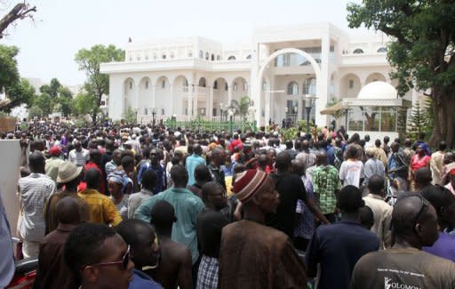Thousands of Malians gather on in front of the presidential compound in Bamako during a protest against a transition deal giving coup leader Amadou Sanogo. Mali's transition president Diancounda Traore was hospitalised Monday after protesters angry at his appointment in a deal struck with the junta burst into his office and beat him