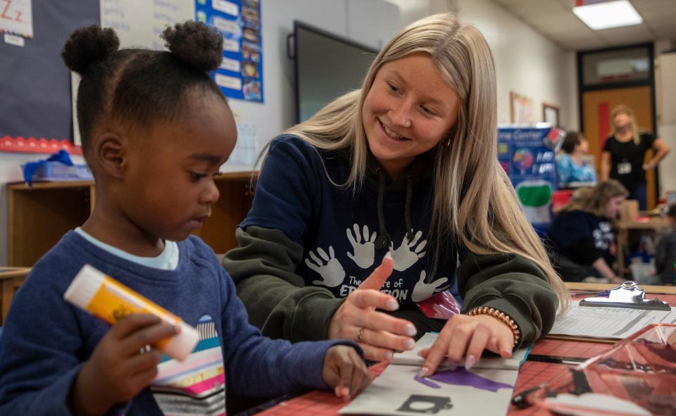 Mattie Gyiraszin, a student at Canton High School, helps a preschool student during a Kiddie Campus class in Canton on Oct. 26, 2023. The Kiddie Campus class is one of the specialized classes offered at the Plymouth-Canton Educational Park that is geared toward students who might find a career related to early childhood education or teaching.