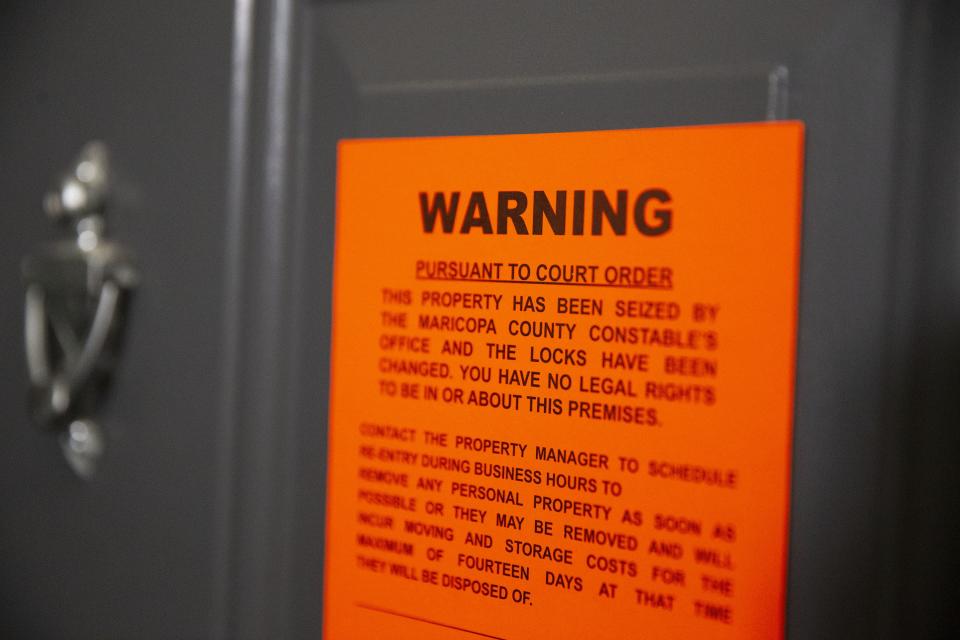 An eviction notice is served at an apartment in east Phoenix in May 2020.