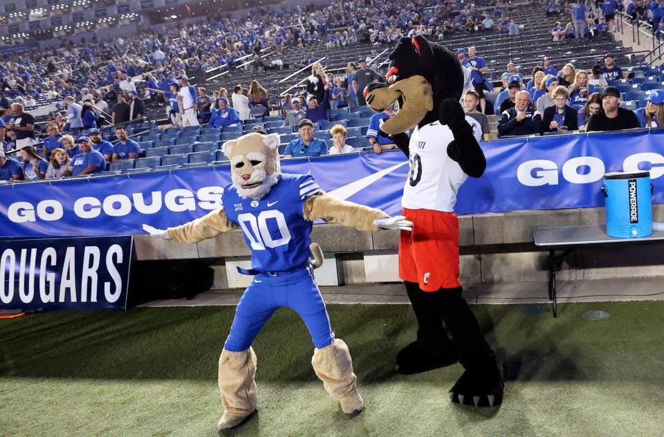 Cosmo and Bearcat interact before the Brigham Young Cougars play the Cincinnati Bearcats at LaVell Edwards Stadium in Provo on Friday, Sept. 29, 2023.