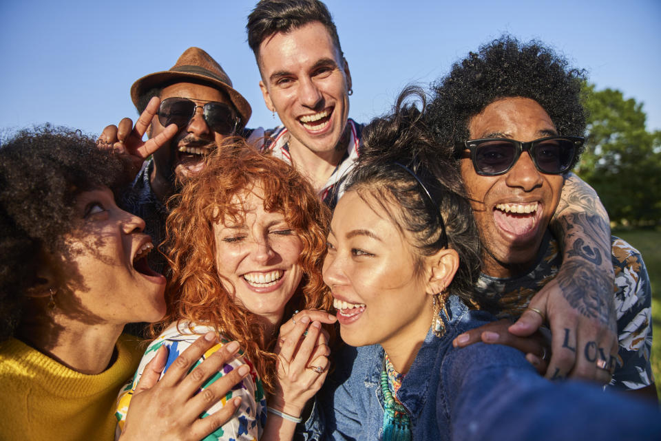 A group of friends take a happy selfie while hanging out