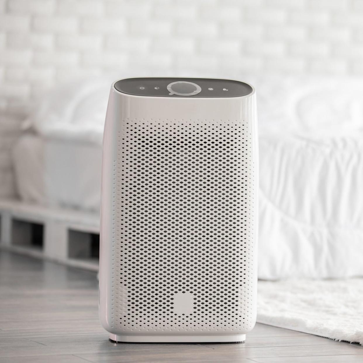 Air purifier in cozy white bed room for filter and cleaning removing dust PM2.5 HEPA in home,for fresh air and healthy life,Air Pollution Concept