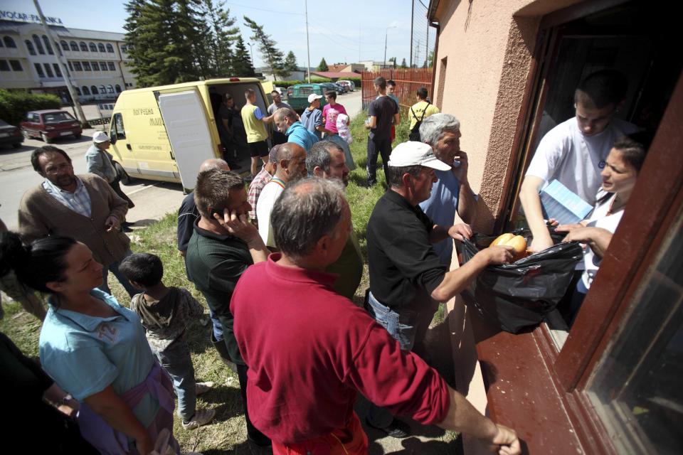 People receive food from volunteers in the town of Smedarevska Palanka