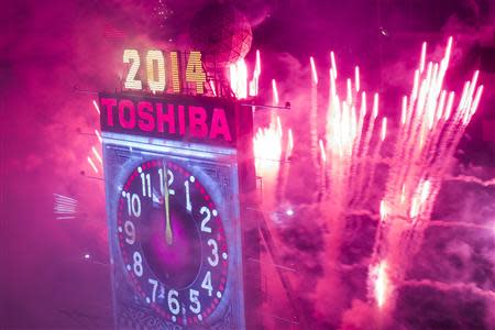 Fireworks explode past the Times Square Ball after it dropped to signal the start of the new year in Times Square, Midtown, New York