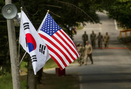 FILE PHOTO: The South Korean and American flags fly next to each other at Yongin, South Korea, August 23, 2016. Courtesy Ken Scar/U.S. Army/Handout via REUTERS/File Photo