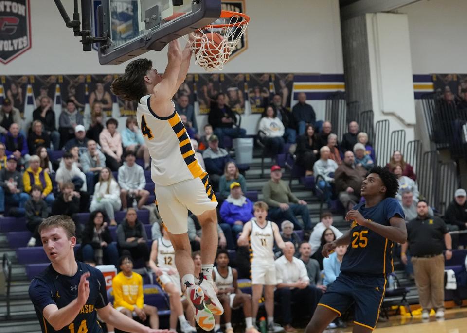 Whiteford’s Hunter DeBarr throws down a two-handed dunk just before the buzzer to seal a 68-62 win over Erie Mason in the semifinals of the Division 3 District at Blissfield Friday night.
