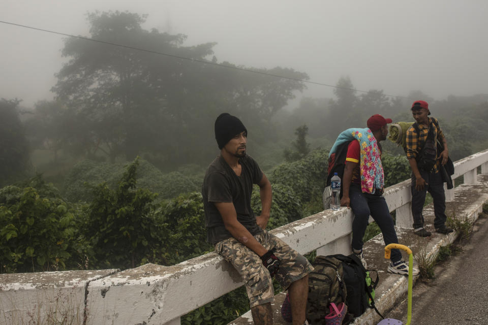 Migrants rest near La Lima in southern Veracruz state, Mexico, Wednesday, Nov. 24, 2021. The Mexican government has recently opted for a new strategy to relieve pressure on Tapachula, the city on its southern border with Guatemala where tens of thousands of migrants accumulate, and to deactivate the caravans that have emerged in recent months: providing humanitarian visas and offering transfers to other states. (AP Photo/Felix Marquez)