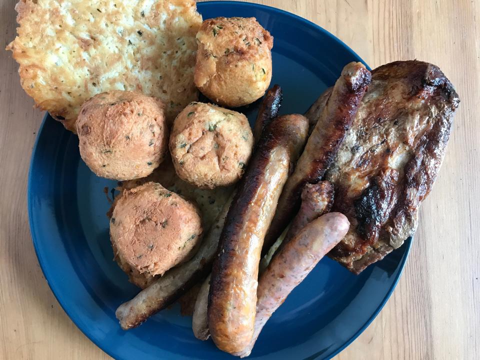 hash browns, sausages, and meat on a plate