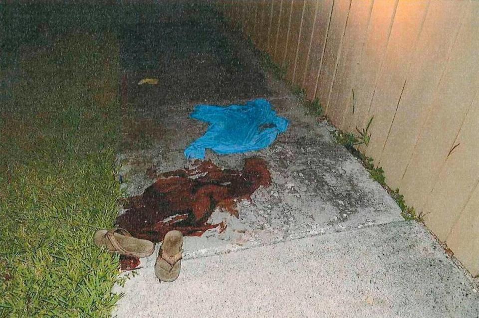 Blood stains a sidewalk after a shooting in the Village of Kendale. Omar Rodriguez faces an attempted murder charge after a shooting that began with a confrontation over dog poop on a lawn.
