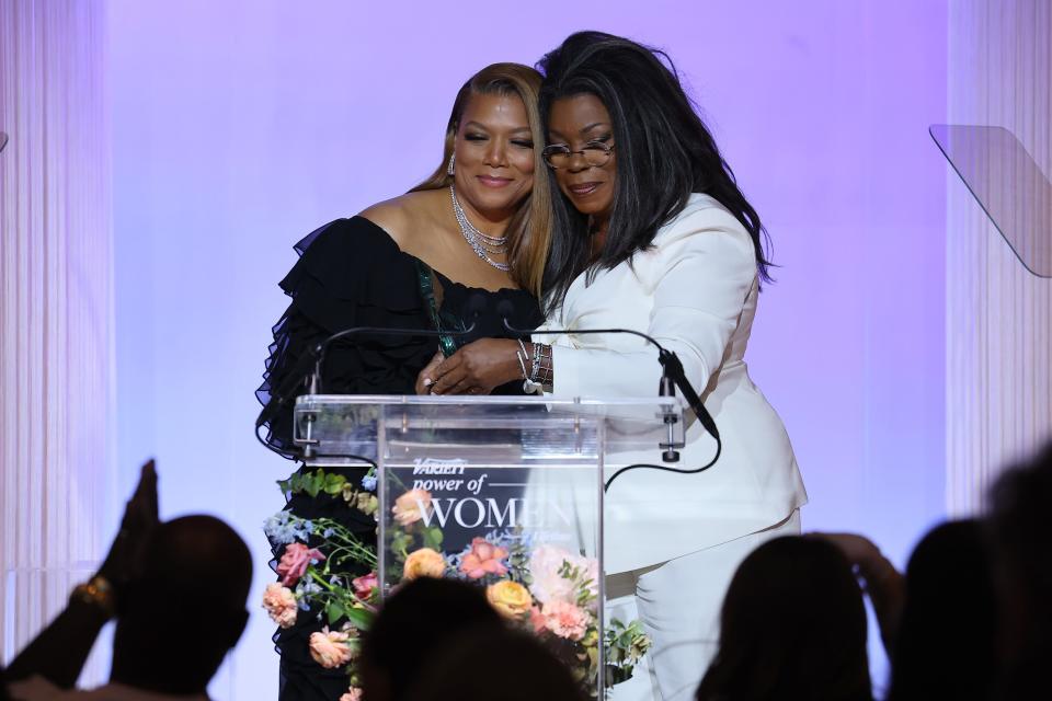 Queen Latifah and Lorraine Toussaint embrace onstage at the Variety Power of Women event.