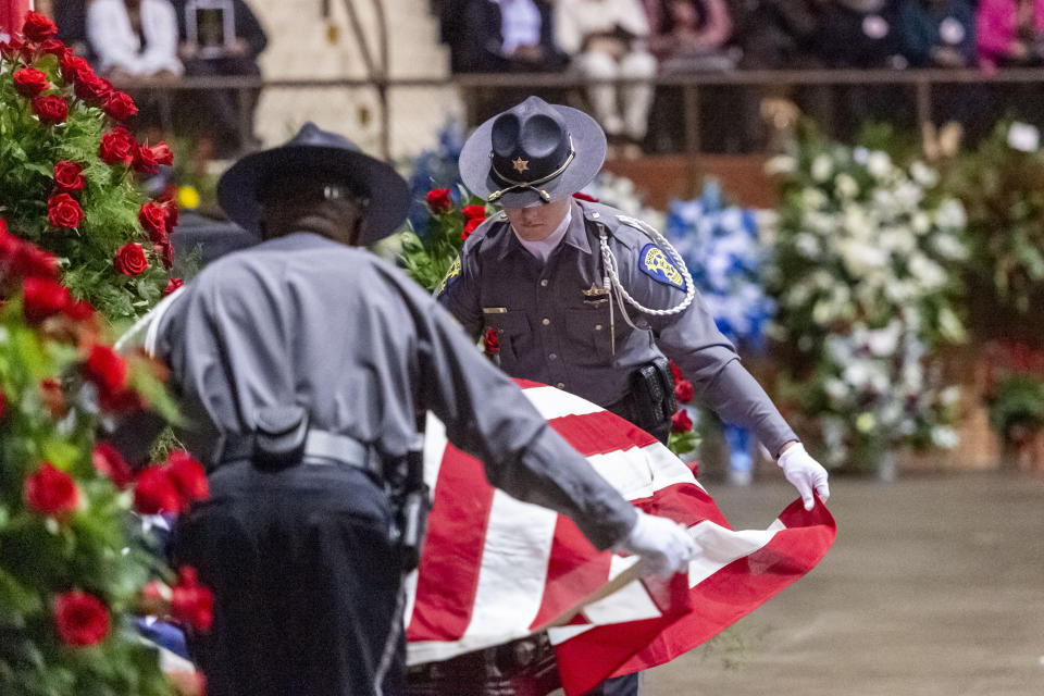 A U.S. flag is placed on the casket during the memorial service for slain Lowndes County Sheriff "Big John" Williams, Monday, Dec. 2, 2019, in Montgomery, Ala. (AP Photo/Vasha Hunt)