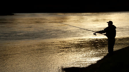 A fsherman casts from the bank on the opening day of the salmon fishing season on the river Tay near Meikleour, Scotland, Britain January 15, 2019. REUTERS/Russell Cheyne