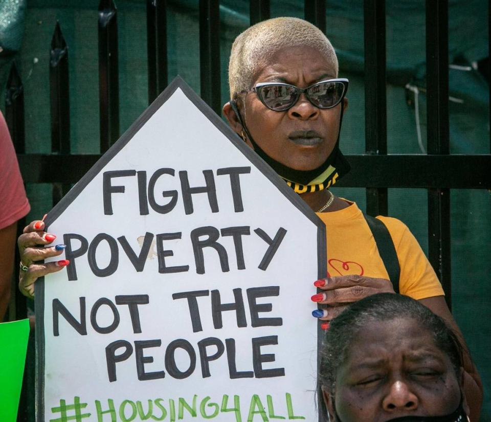Frederica Dawson holds a sign in protest outside Elena Riech’s house in Allapattah on June 8, 2021. Riech is a single mother of three in danger of being evicted even though she qualified for governmental assistance.