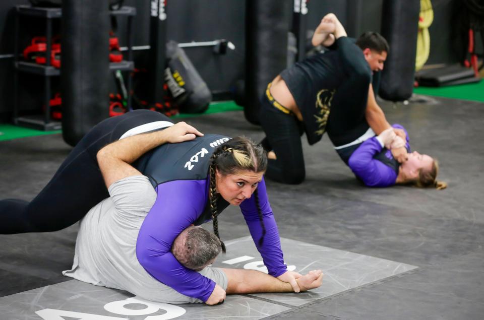 Jenn Kozlowski,, left, wrestles with opponent Jason Fredericks, while Maggie Wickenhauser, right, deals with opponent Elian Solis during a Jiu Jitsu class, Monday, November 13, 2023, in Sheboygan, Wis.