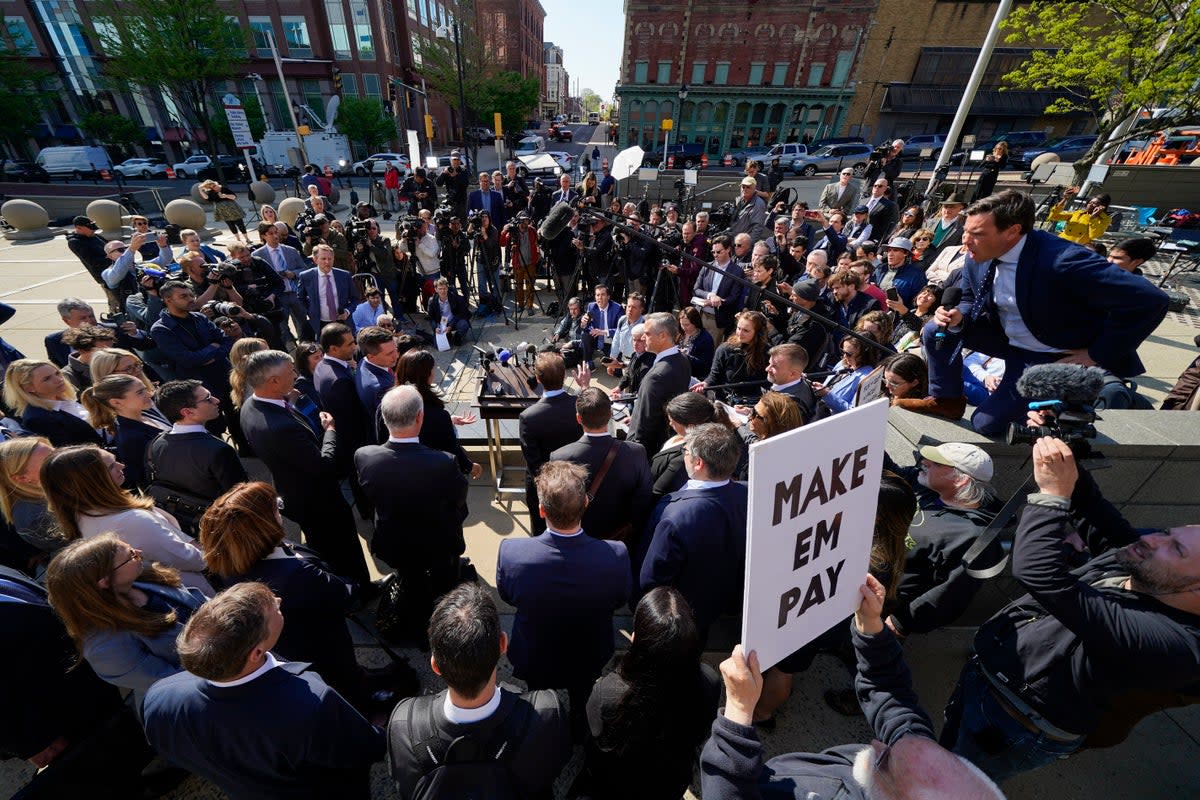 Reporters surround attorneys for Dominion Voting Systems during a news conference outside the New Castle County Courthouse in Wilmington, Delaware, after the defamation lawsuit against Fox News was settled on Tuesday, April 18, 2023 (Copyright 2023 The Associated Press. All rights reserved)