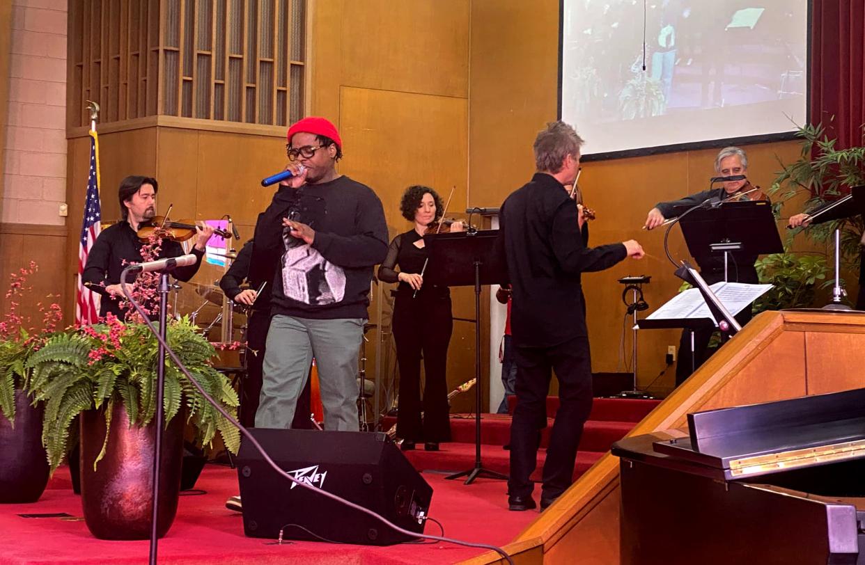 Rapper, activist and entrepreneur Jabee Williams, alongside Maestro Alexander Mickelthwate, at Williams' right, performs a musical selection with the Oklahoma City Philharmonic at Fifth Street Baptist Church, 801 NE 5, the home church of the late civil rights leader Clara Luper. [Provided} 