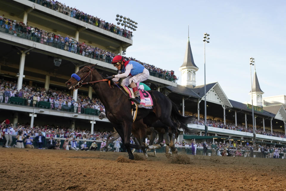 FILE - John Velazquez riding Medina Spirit crosses the finish line to win the 147th running of the Kentucky Derby at Churchill Downs in Louisville, Ky., in this Saturday, May 1, 2021, file photo. Medina Spirit was stripped of the victory in last year’s Kentucky Derby and Mandaloun was declared the winner in a ruling by state racing stewards on Monday, Feb. 21, 2022. (AP Photo/Jeff Roberson, File)